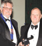 SAIS chairman, Errol Peace awarding Terry Scallan the Institute Crystal of Appreciation in recognition of the commitment made to the Institute by Scallan.